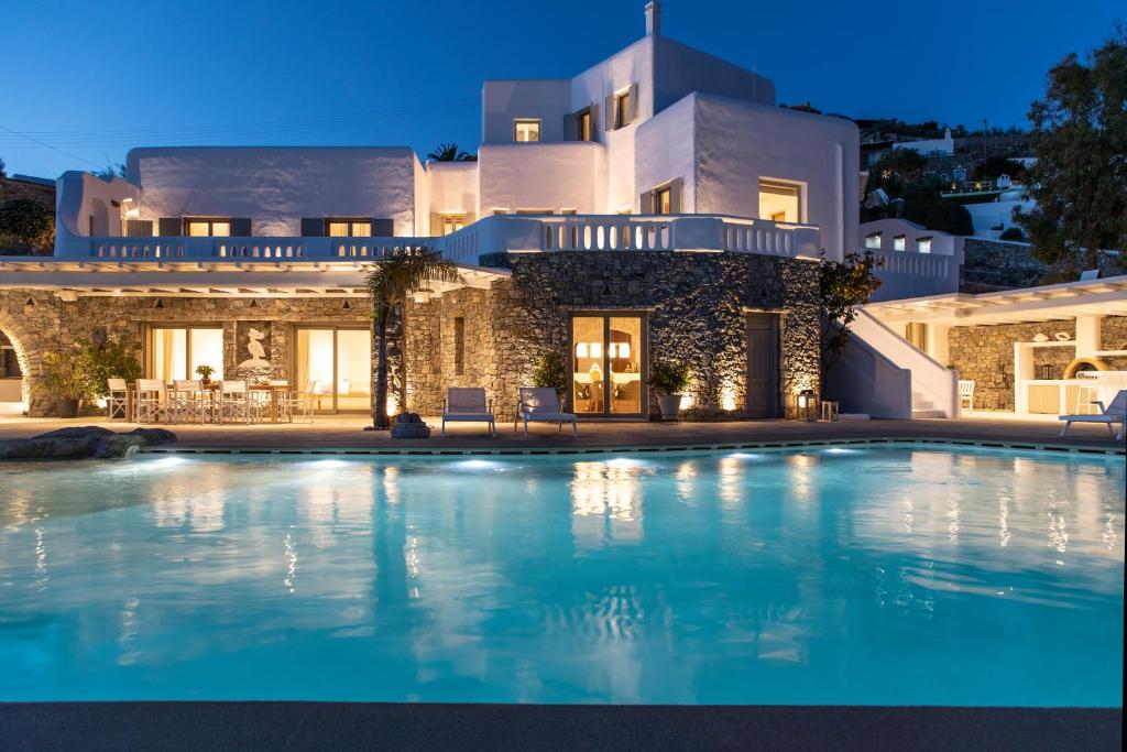 a large swimming pool in front of a house at Villa Ker by Ethos Hospitality- 5 Bedrooms in Mýkonos City