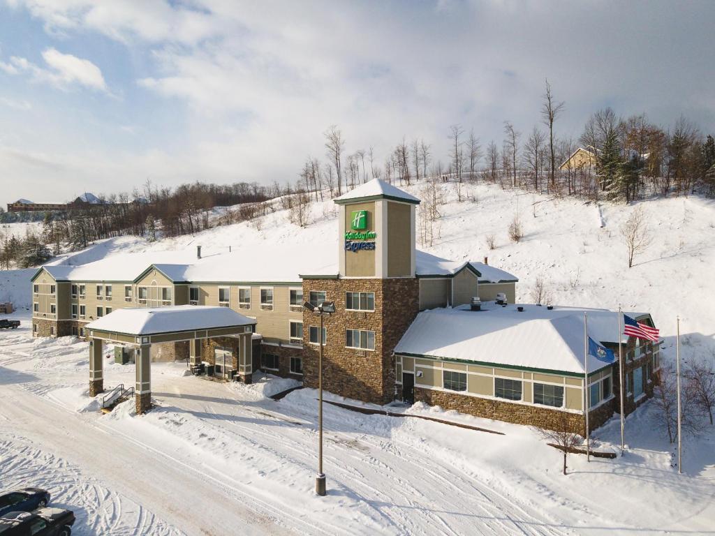 a large building with a snowboard on top of it at Holiday Inn Express Houghton-Keweenaw, an IHG Hotel in Houghton