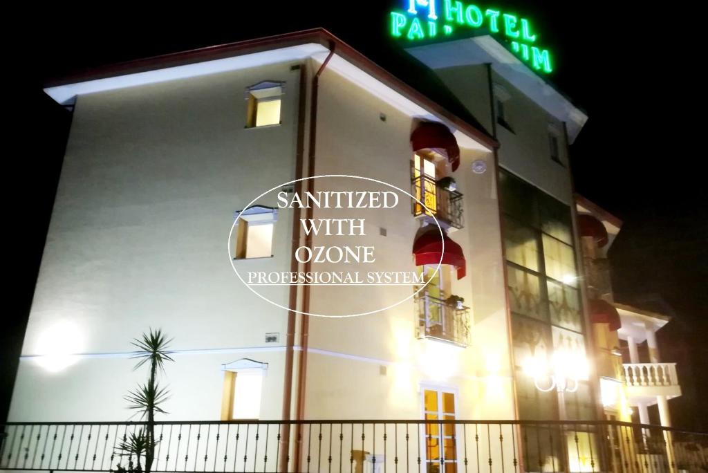 a building with a sign on the side of it at Hotel Palladium in Monastir