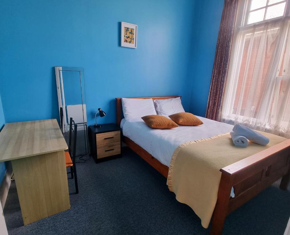 Postel nebo postele na pokoji v ubytování Dunedin Classic Stay