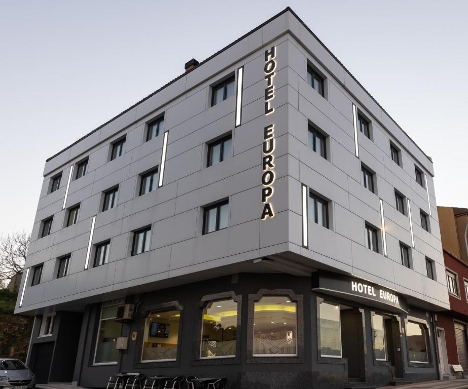 a large white building with a sign on it at Hotel Europa in Arteixo