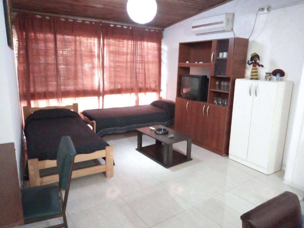 a living room with a couch and a refrigerator at DEPTO FAMILIAR dolar billete dolar blue in Gualeguaychú