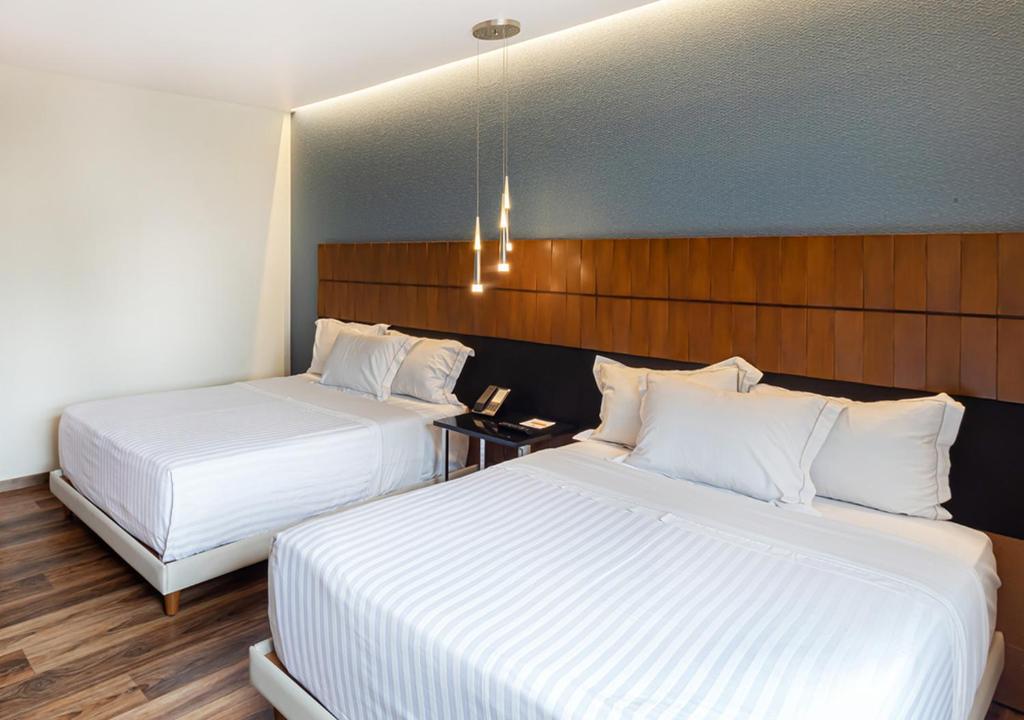 Postel nebo postele na pokoji v ubytování Hotel Real del Rio