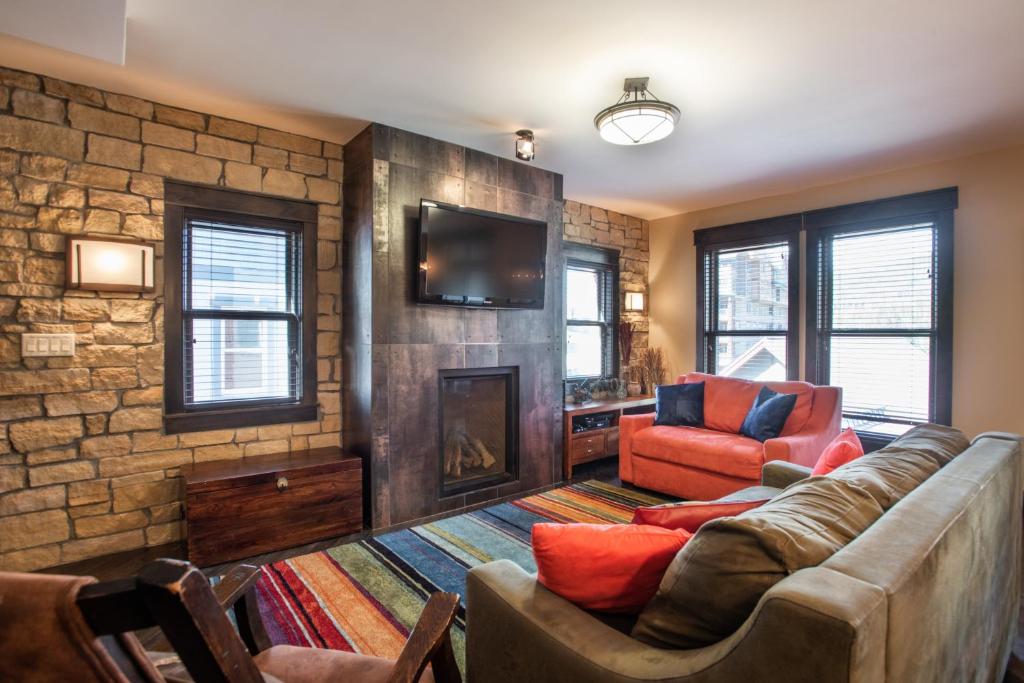 a living room with a couch and a fireplace at Spacious Village View Townhouse with Fireplace at Parry Peak Lofts townhouse in Winter Park