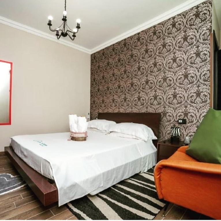 a bedroom with a large bed and a wall at CLARISSABEB in Fiumicino