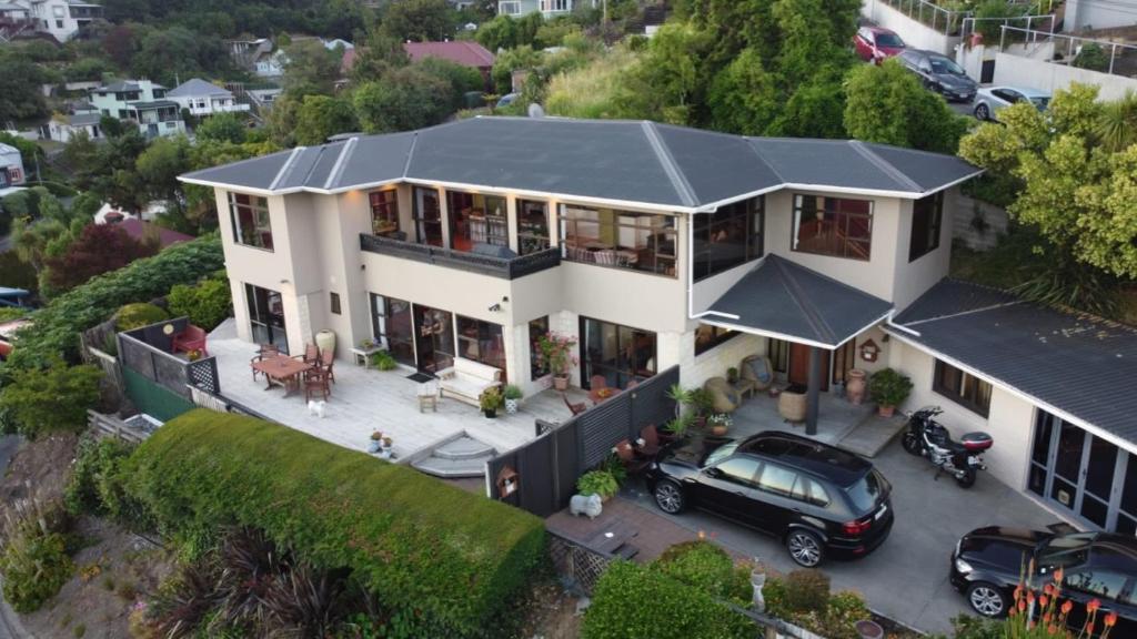 an aerial view of a house with a car parked in a parking lot at Harbour Lodge in  Lyttelton