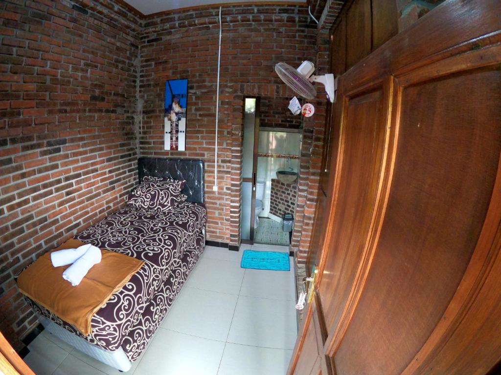 Postel nebo postele na pokoji v ubytování Wisma Pancoeran