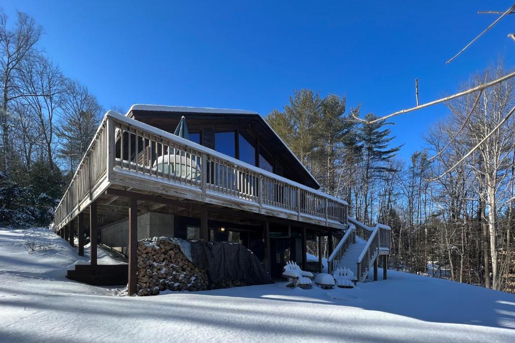 una cabaña de madera en la nieve en el bosque en Free in VT en Cavendish