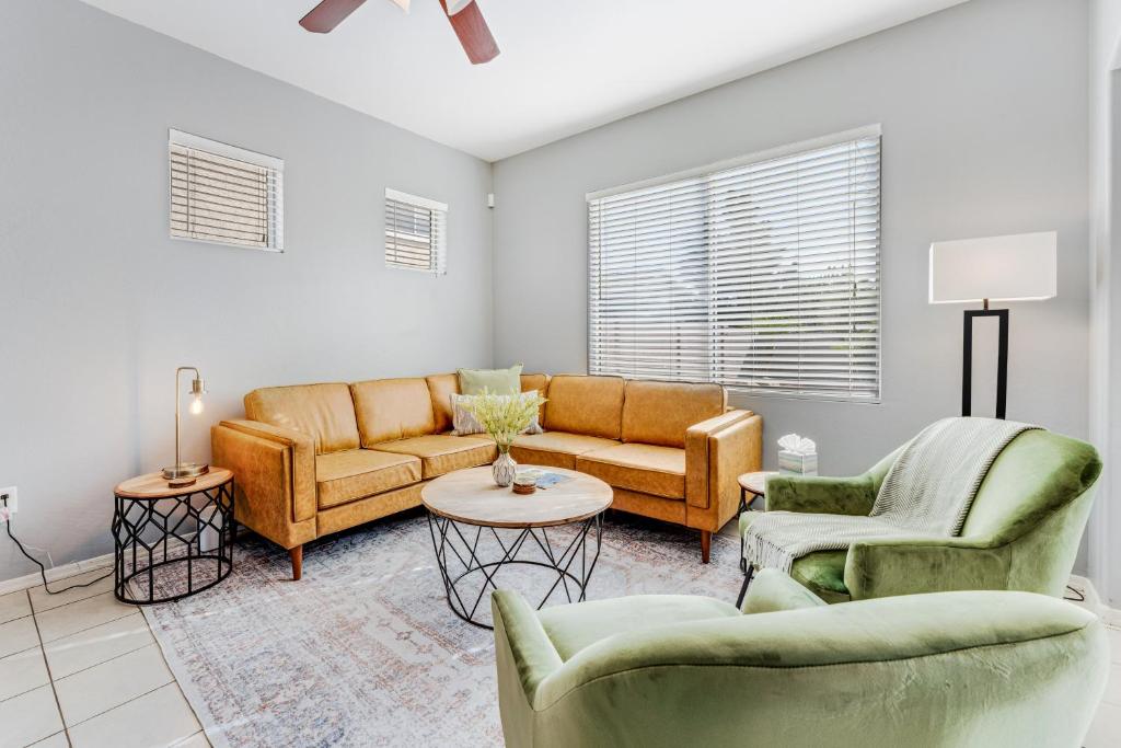 a living room with couches and chairs and a table at Palm Paradise in Avondale