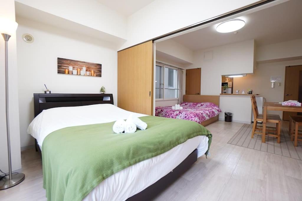 a bedroom with a bed with a stuffed animal on it at 長期割引 豊水すすきの駅からすぐ IK Minami 6 Jo Residence 803 IK南6条レジデンス in Sapporo