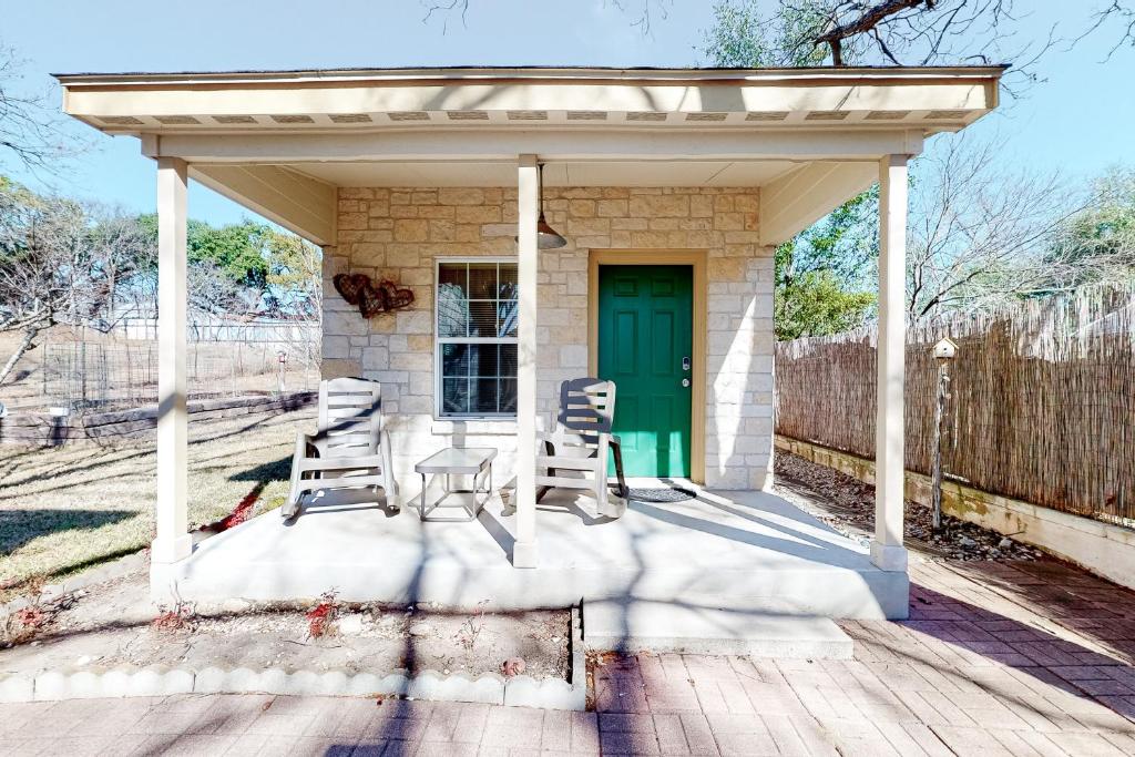 a gazebo with chairs and a table on a porch at Sip & Stay in Fredericksburg