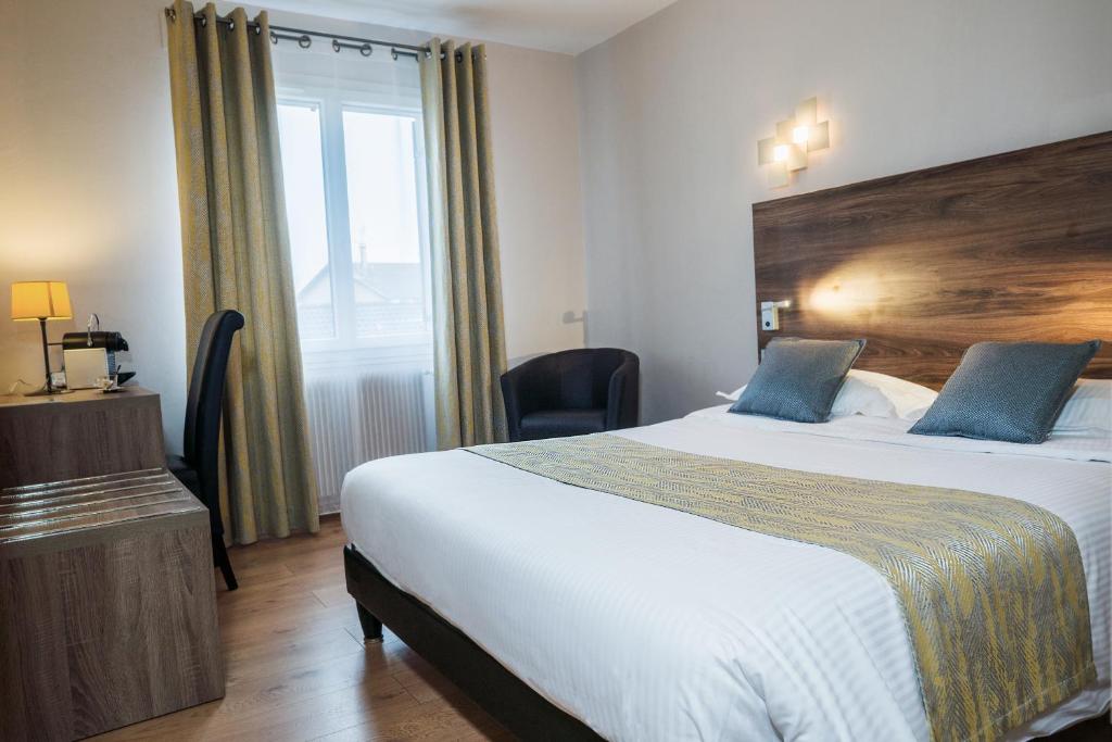 Postel nebo postele na pokoji v ubytování Logis Hotel Le Petit Casset