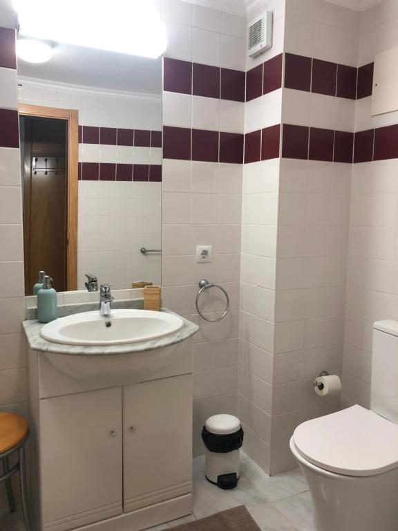a bathroom with a sink and a toilet at Ericeira Surf and Sun in Ericeira