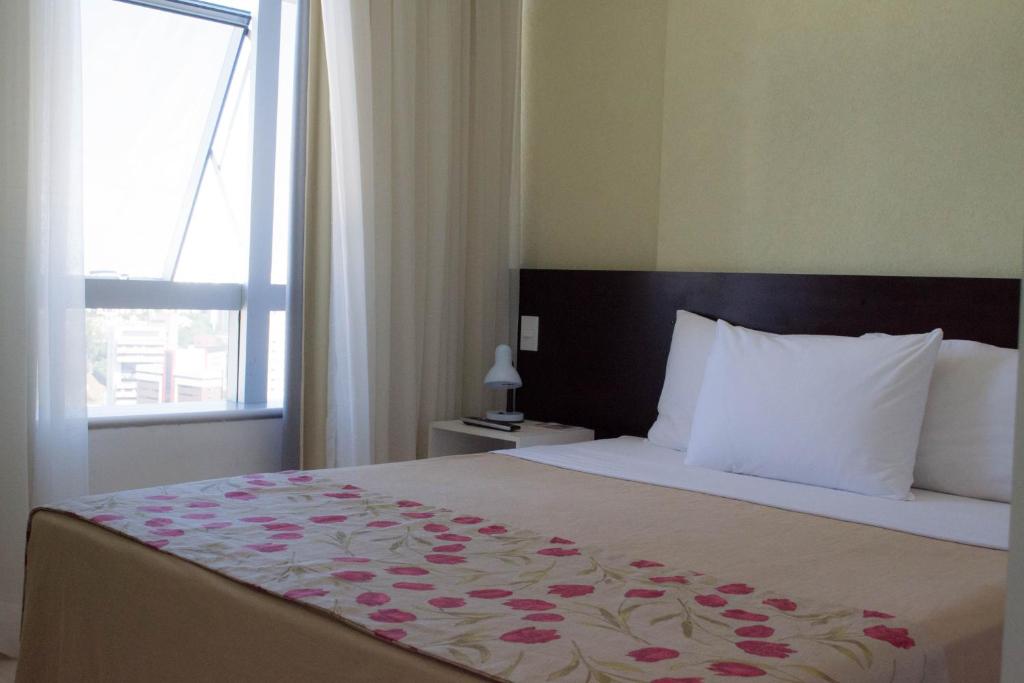 Postel nebo postele na pokoji v ubytování Iguatemi Business & Flat by Avectur