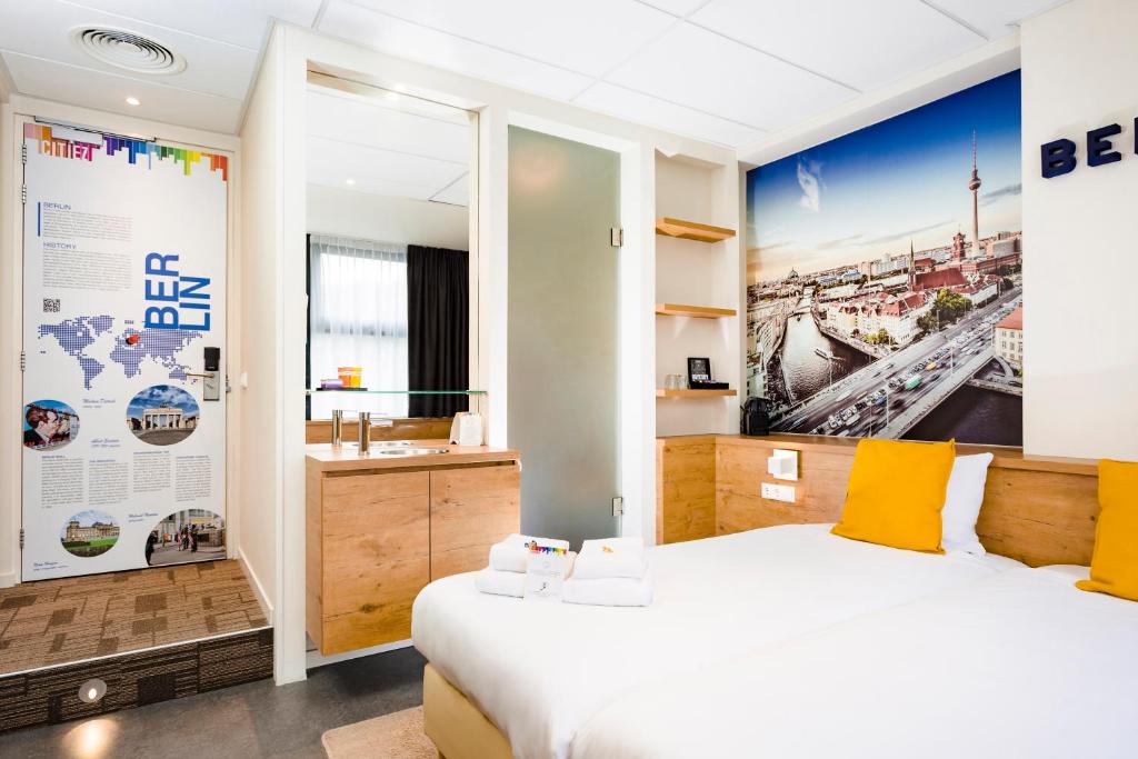 a bedroom with a bed and a bathroom with a sink at Citiez Hotel Amsterdam in Amsterdam