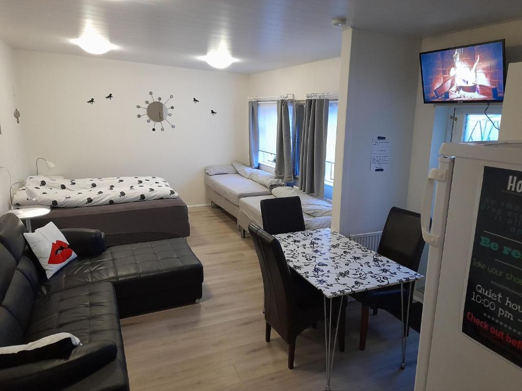 a living room with a couch and a table at Aurora Studio apartment completely private in Keflavík