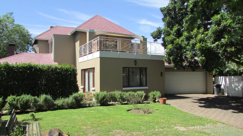 a house with a balcony on top of it at Pinewoods Rest in Somerset West