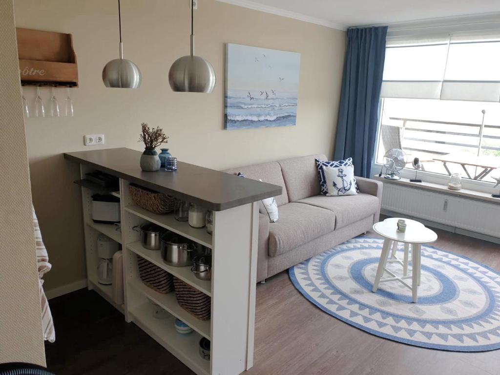 a living room with a couch and a table at Apartment Fördeblick in Damp