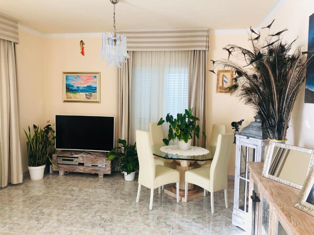 奧爾比亞的住宿－Best Sardegna，客厅配有桌子和电视