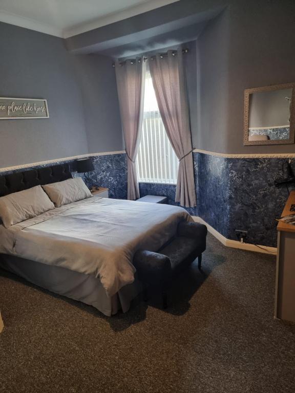 a bedroom with a large bed and a window at Thornhill Blackpool in Blackpool