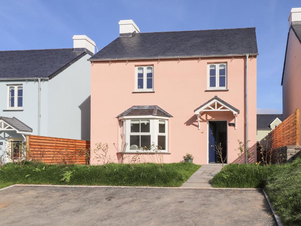 a pink house with a black roof at 4 Llain yr Eglwys in Newport