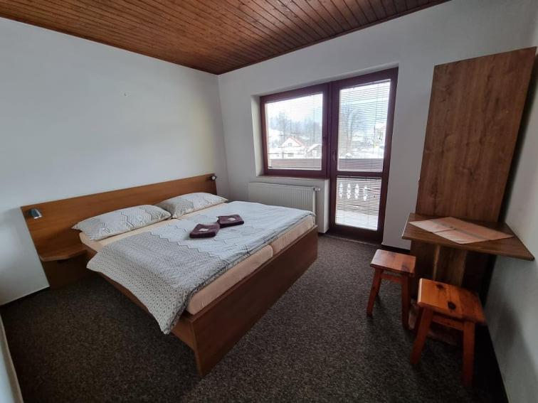 Posteľ alebo postele v izbe v ubytovaní Penzion Goral