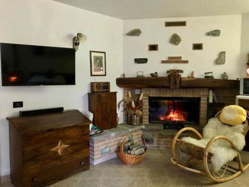 a living room with a fireplace and a tv at La Cà Granda 