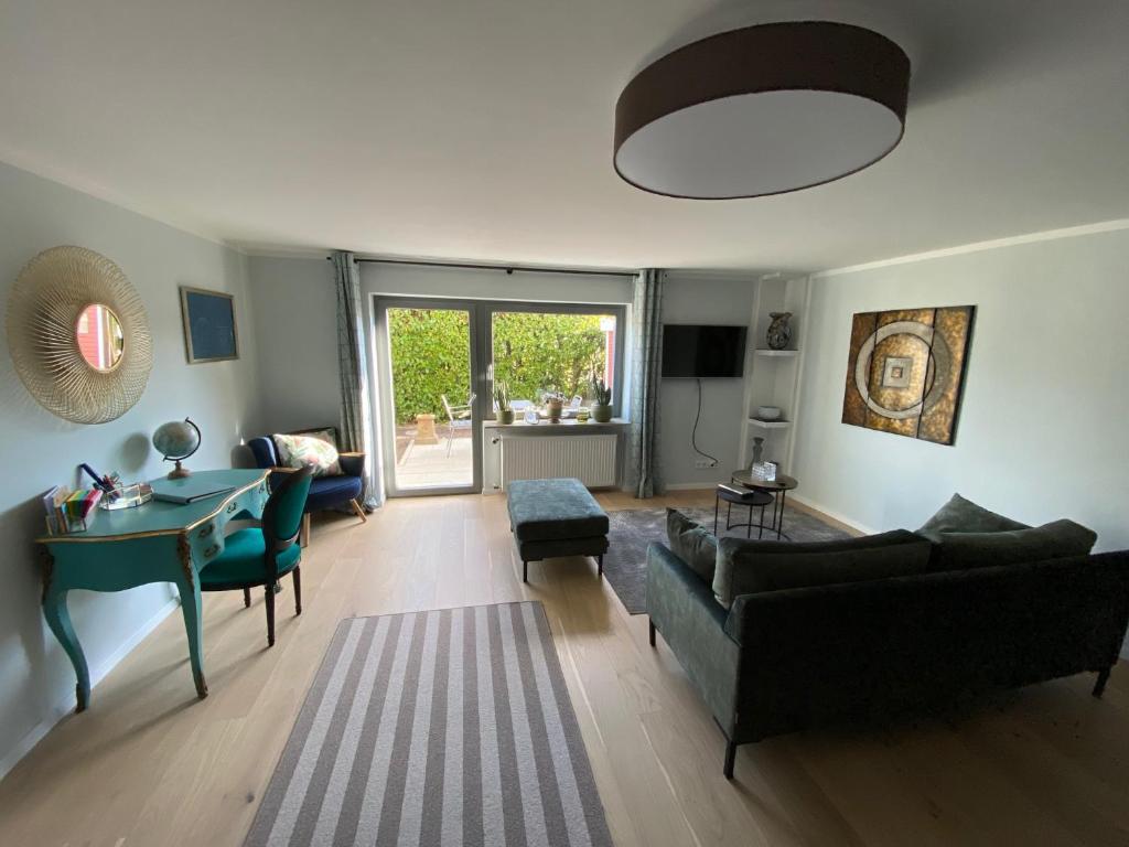 ein Wohnzimmer mit einem Sofa und einem Tisch in der Unterkunft Schöne Wohnung mit Ausblick und Gartensitzplatz in Lörrach