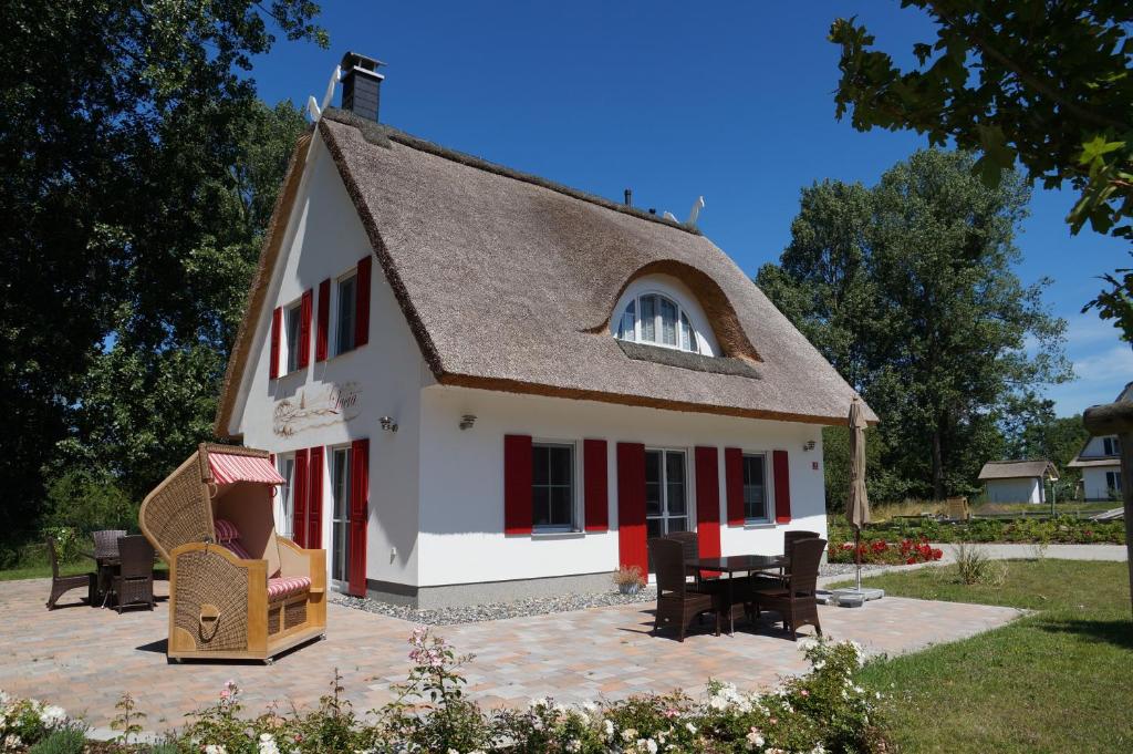 a replica of a house with a patio at Ferienhaus Lucia in Glowe