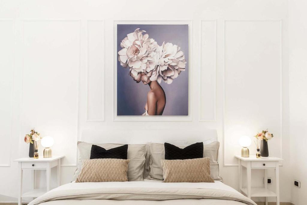 a bedroom with a bed with a large flower above it at Appartamento Corfù in Lido di Ostia