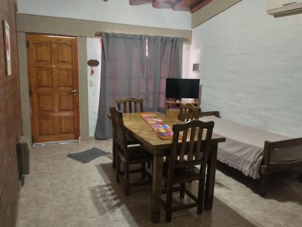 a bedroom with a table and chairs and a bed at Amaru Apart in La Consulta