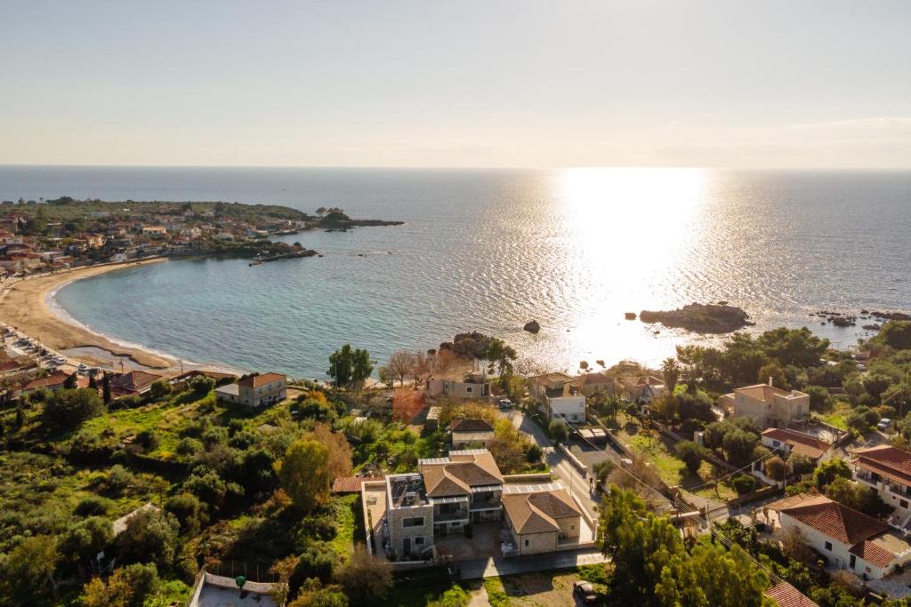 an aerial view of a beach with houses and the ocean at Linari Villas in Stoupa