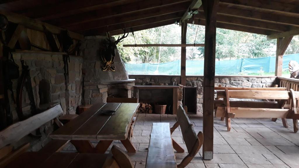 a room with a table and chairs in a cabin at apartmány pod Vysákem in Stárkov