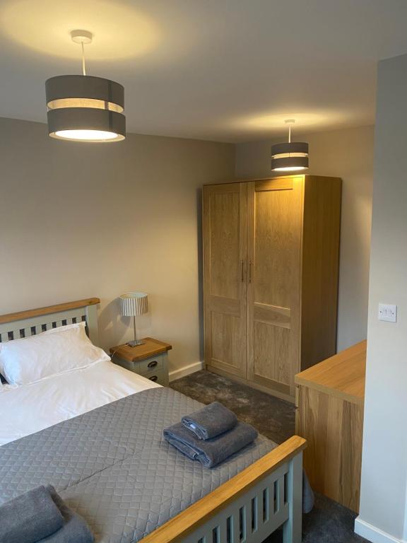 um quarto com uma cama com duas toalhas em THE ESK - Modern 1 bedroom apartment in centre of Melrose. em Melrose