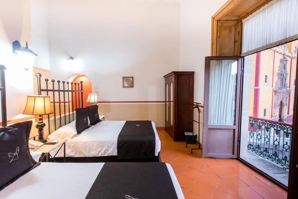 Postel nebo postele na pokoji v ubytování Hotel de la Paz
