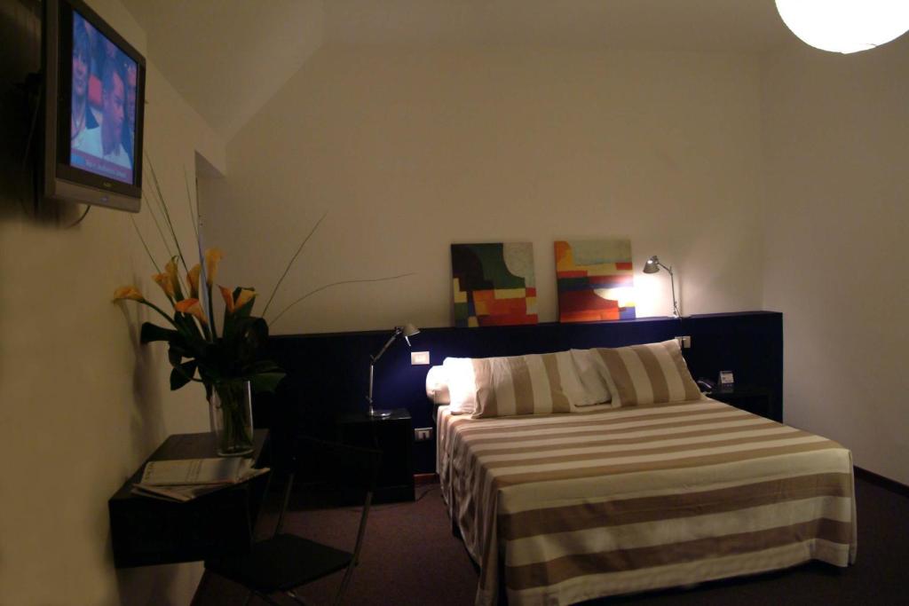 Postel nebo postele na pokoji v ubytování Hotel Orvieto