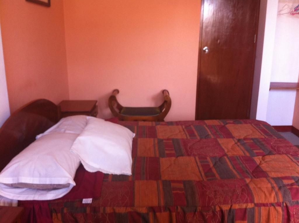 Postel nebo postele na pokoji v ubytování Hostal Tres Máscaras