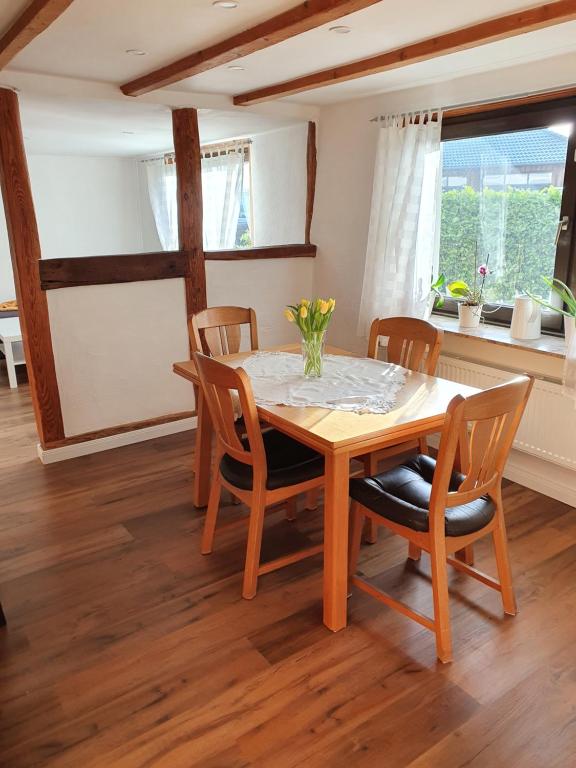 a dining room with a wooden table and chairs at Gemütliches Fachwerk im Oberbergischen in Wiehl