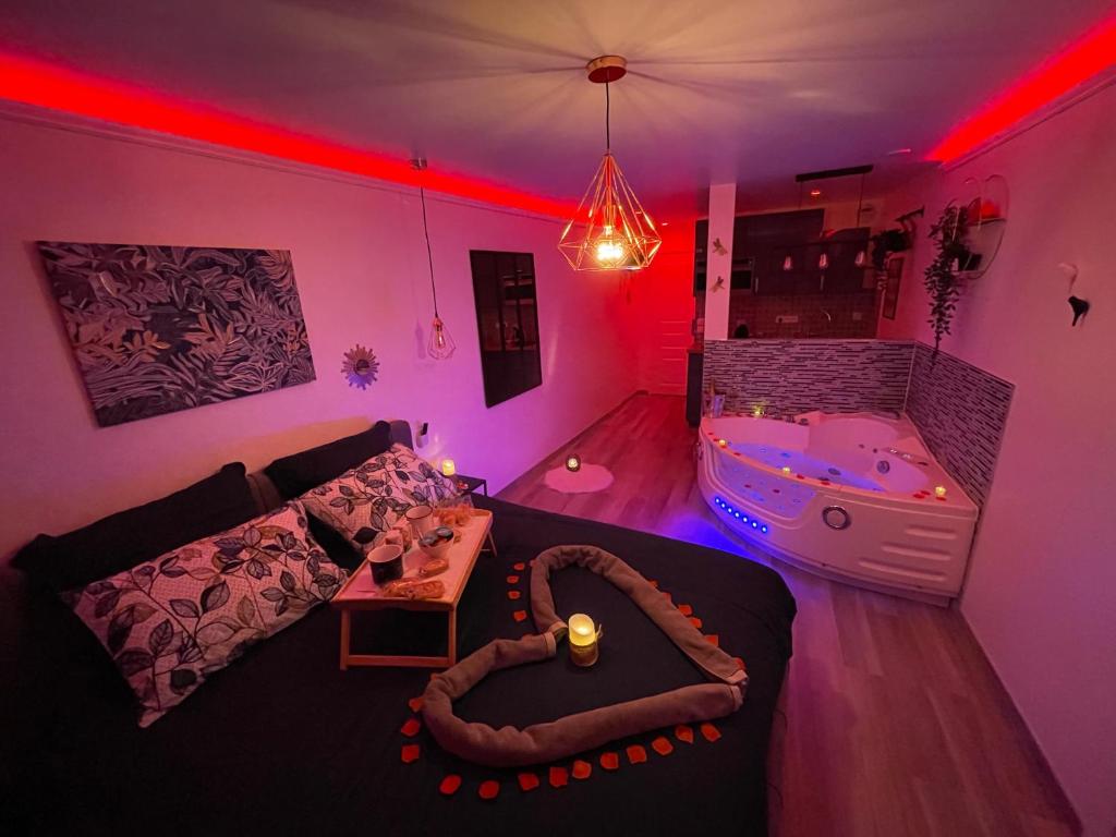 sala de estar con bañera y sofá en Bulle d'Amour, en Pontault-Combault