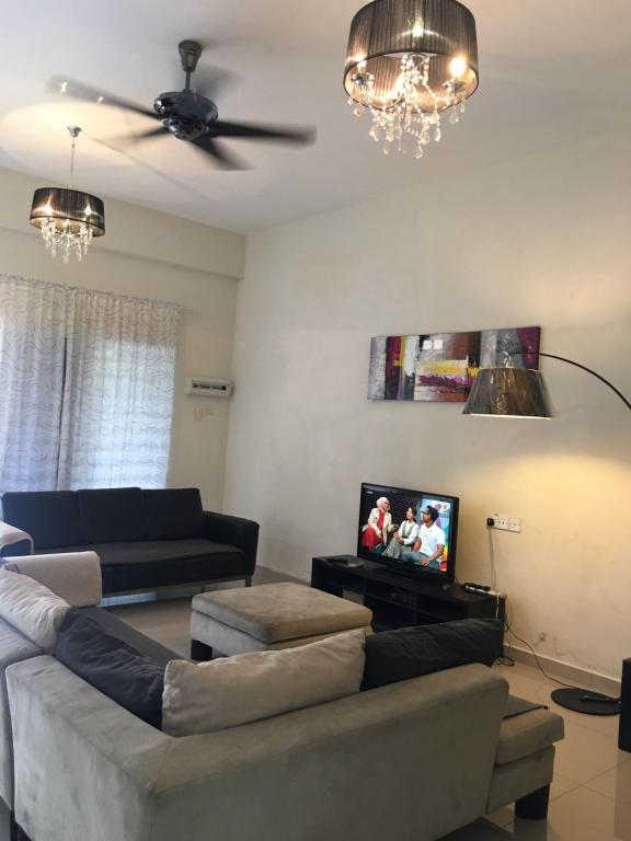 a living room with a couch and a flat screen tv at KS Lavender Kuala Kangsar in Kuala Kangsar
