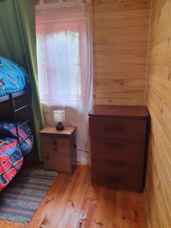 Postel nebo postele na pokoji v ubytování Cabañas Los Castaños Chovellén