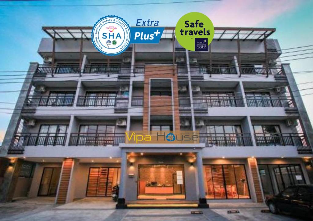 a building with two signs on the front of it at Vipa House Phuket - SHA Extra Plus in Chalong 