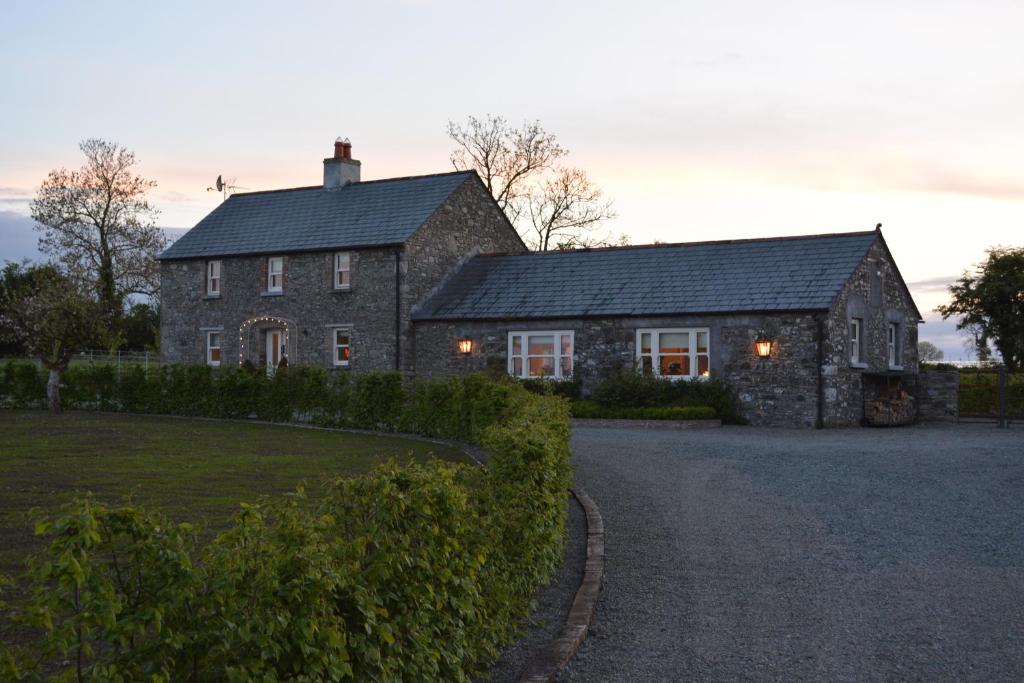 a large brick house with a dark roof at Hideaway at Foxhollow in Kells