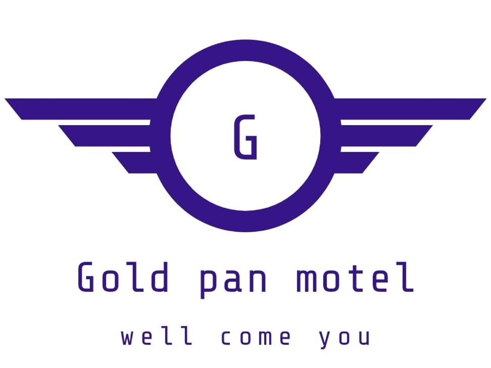 a logo for a gold pan motel well come you at Gold Pan Motel in Quesnel