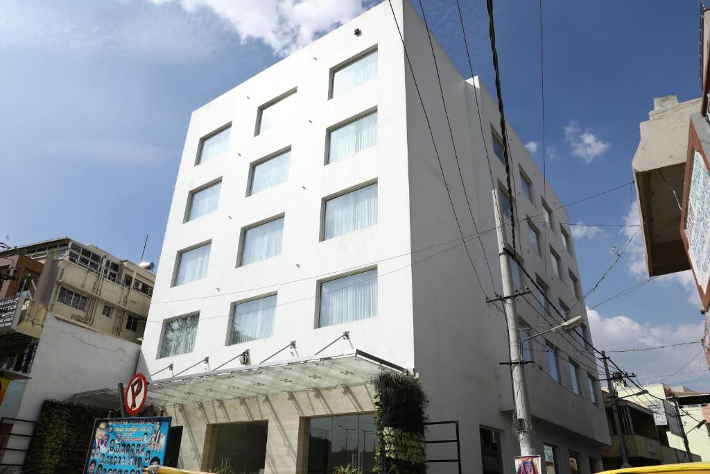 a white building on the side of a street at YN Hotels in Bengaluru