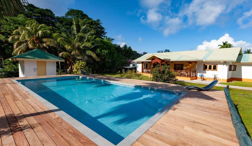 a swimming pool in front of a house at JMS Ventures in La Digue