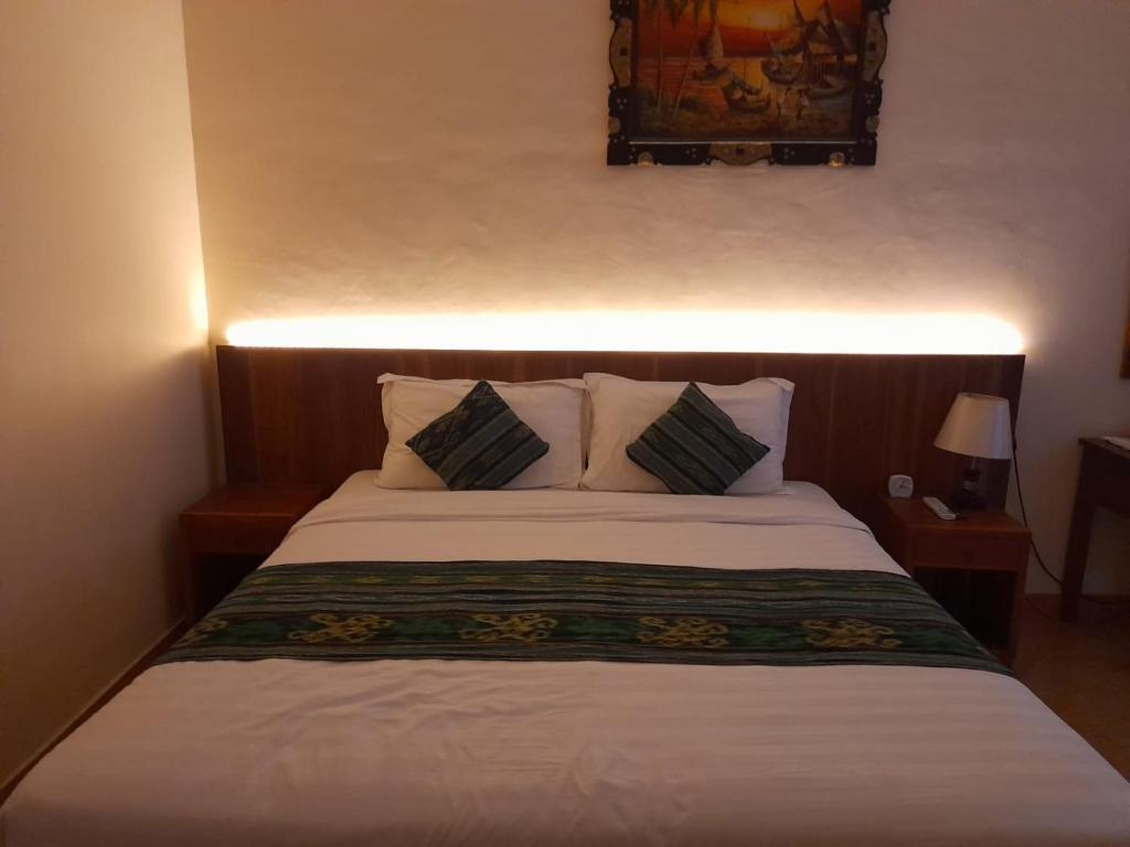 Postel nebo postele na pokoji v ubytování Kuta Paradise