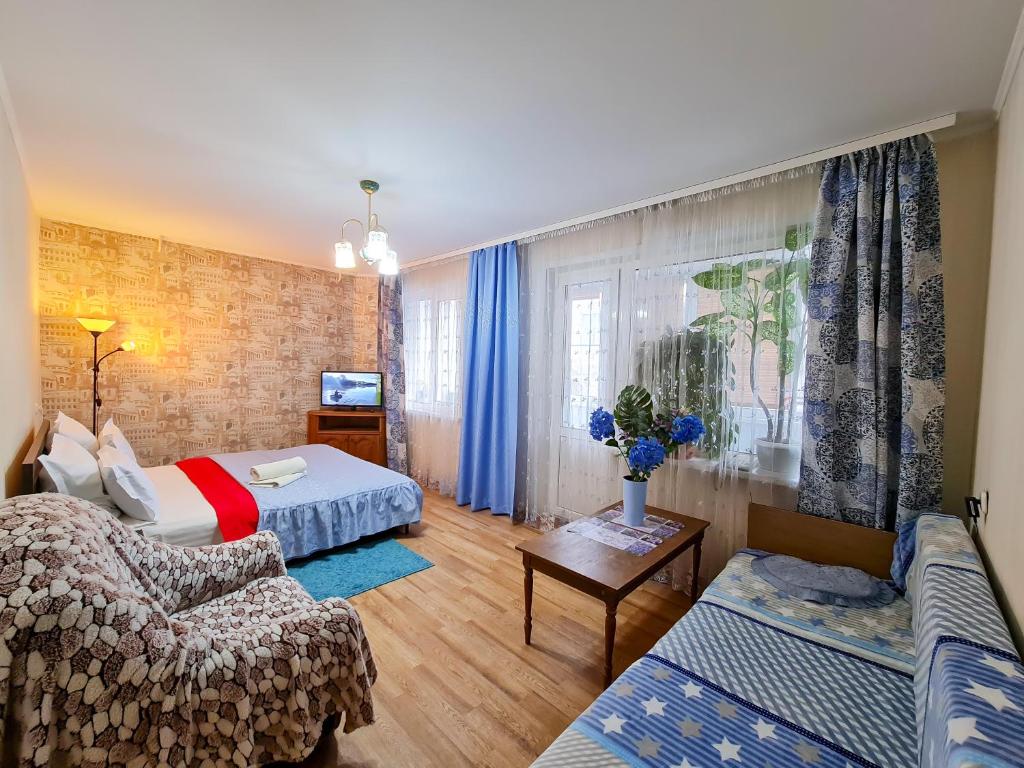 a living room with a bed and a couch at Apartment on Prospect Octyabrya in Gomel