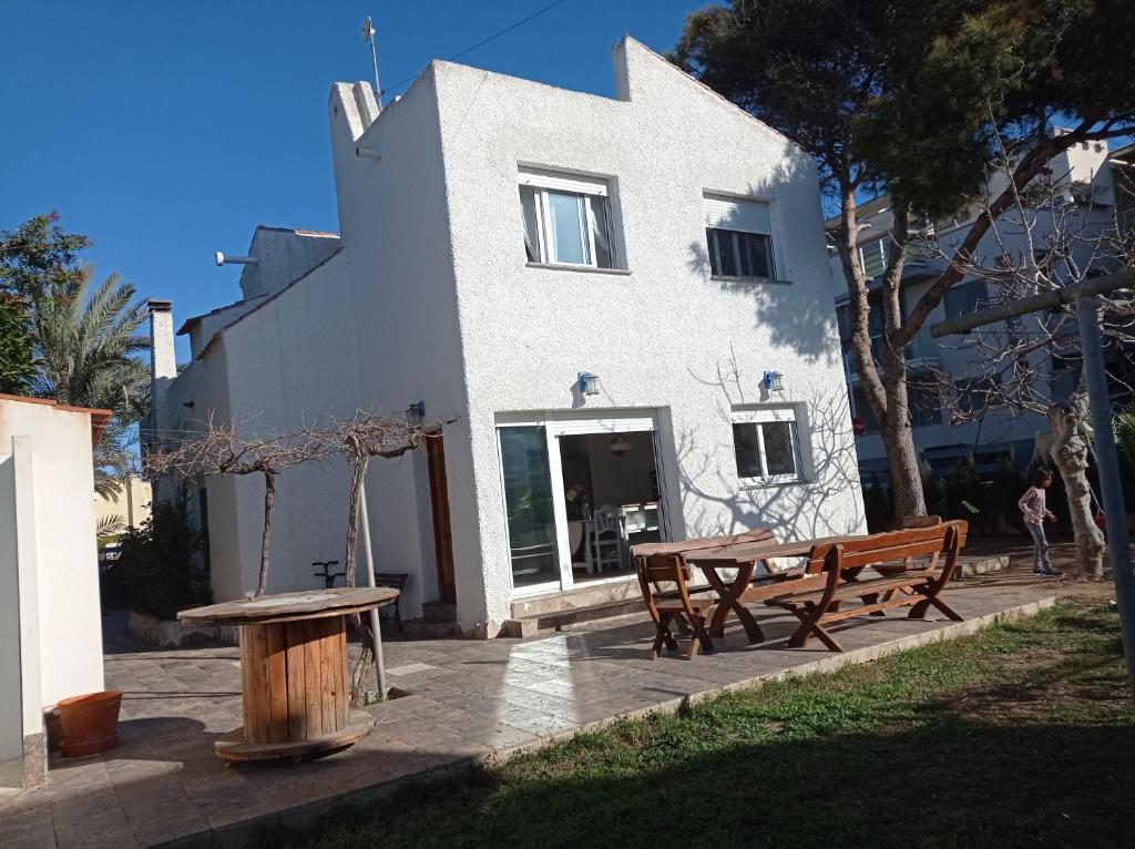 a building with a table and benches in front of it at The Blue Family House in Cabo de Palos