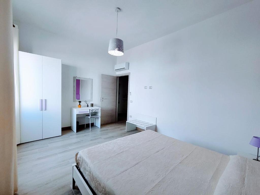 A bed or beds in a room at Sa Banita affittacamere